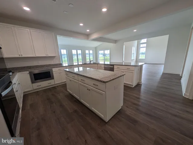 a kitchen with sink stove and cabinets