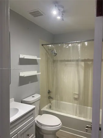 a bathroom with a toilet a sink and shower