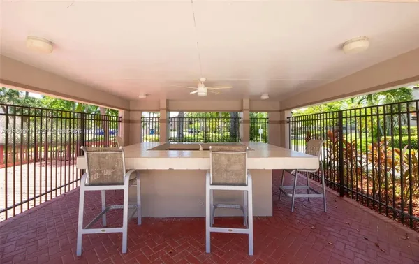 a dining room with furniture and a floor to ceiling window