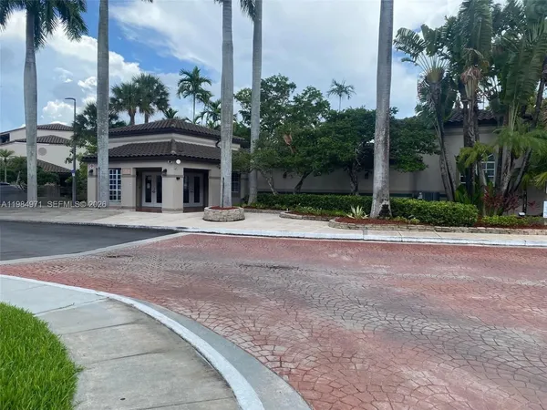 a front view of a house with garden and plants