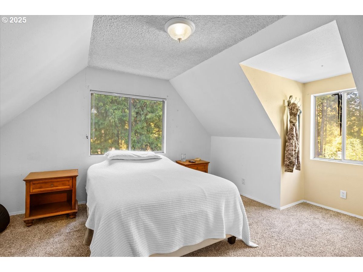 800 Byron Creek Road Winston, OR 97496 - Photo 32 of 35 a bedroom with a bed and a large window