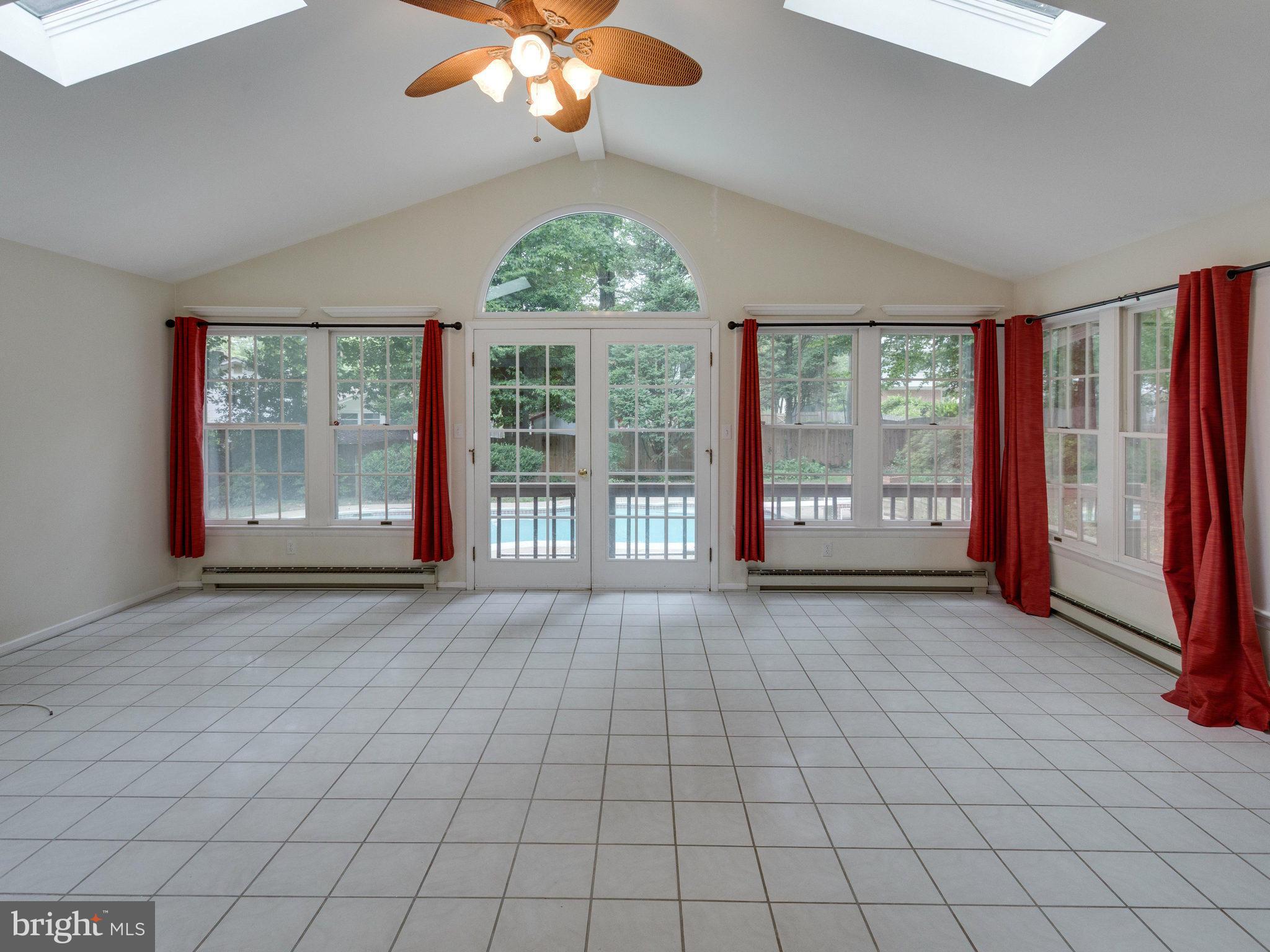 10022 Ranger Road Fairfax, VA 22030 - Photo 11 of 30 an empty room with floor to ceiling windows and chandelier