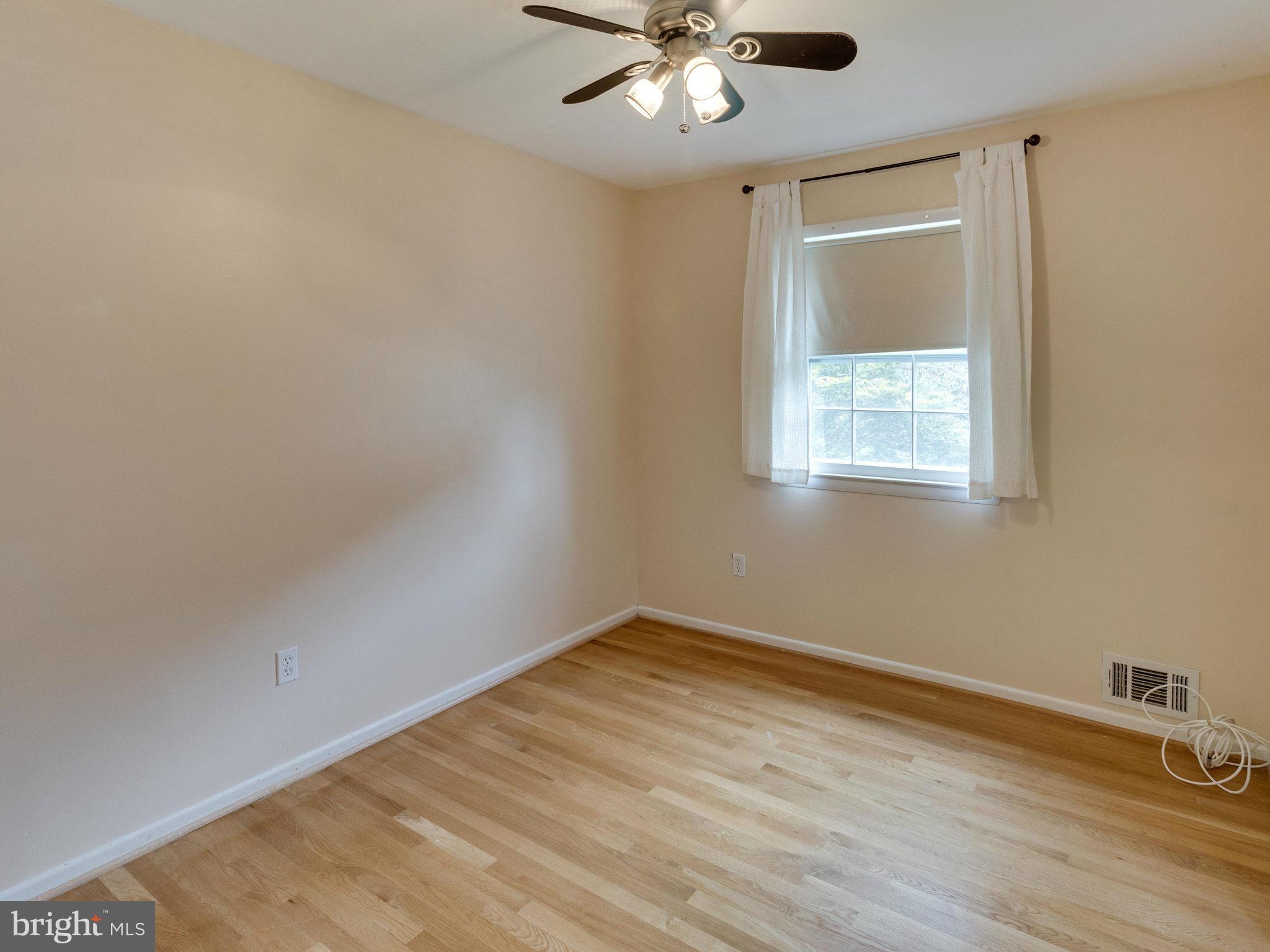 10022 Ranger Road Fairfax, VA 22030 - Photo 15 of 30 a view of an empty room with wooden floor and a window