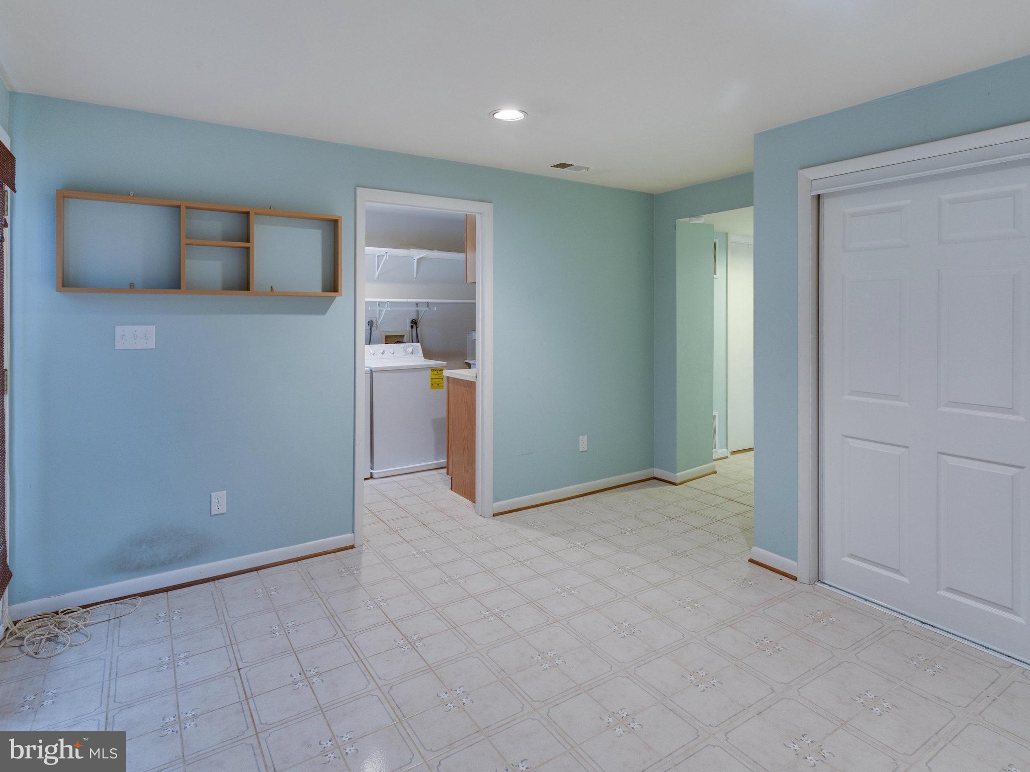 10022 Ranger Road Fairfax, VA 22030 - Photo 23 of 30 an empty room with kitchen and natural light