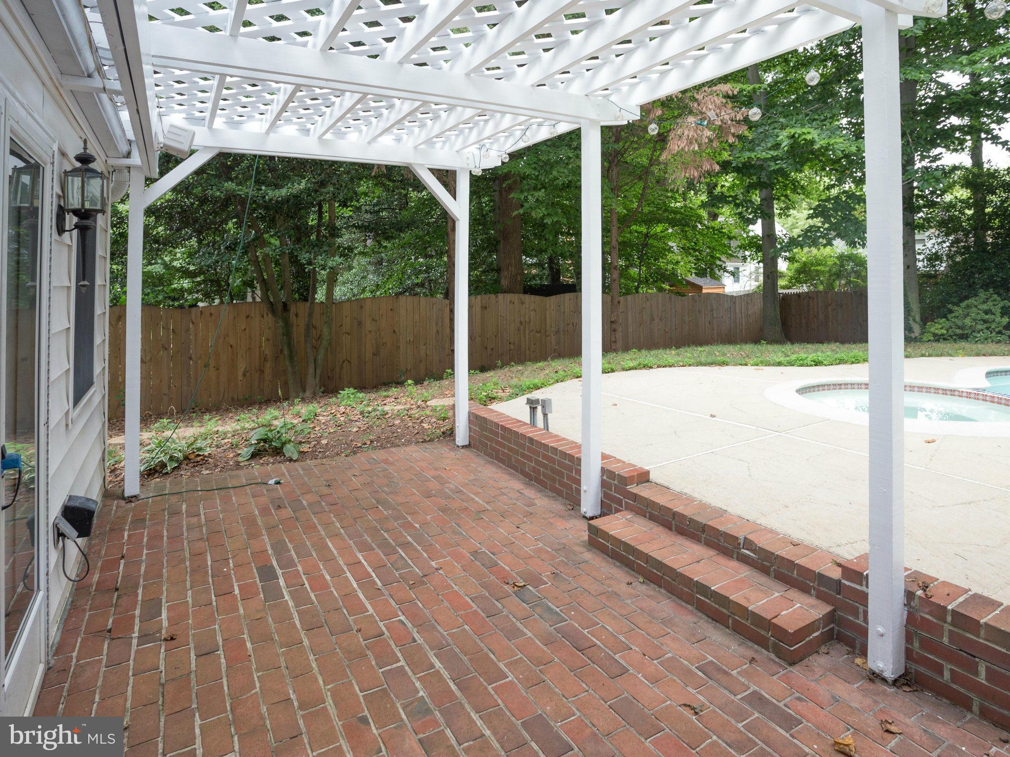 10022 Ranger Road Fairfax, VA 22030 - Photo 26 of 30 a view of backyard with large trees and wooden fence