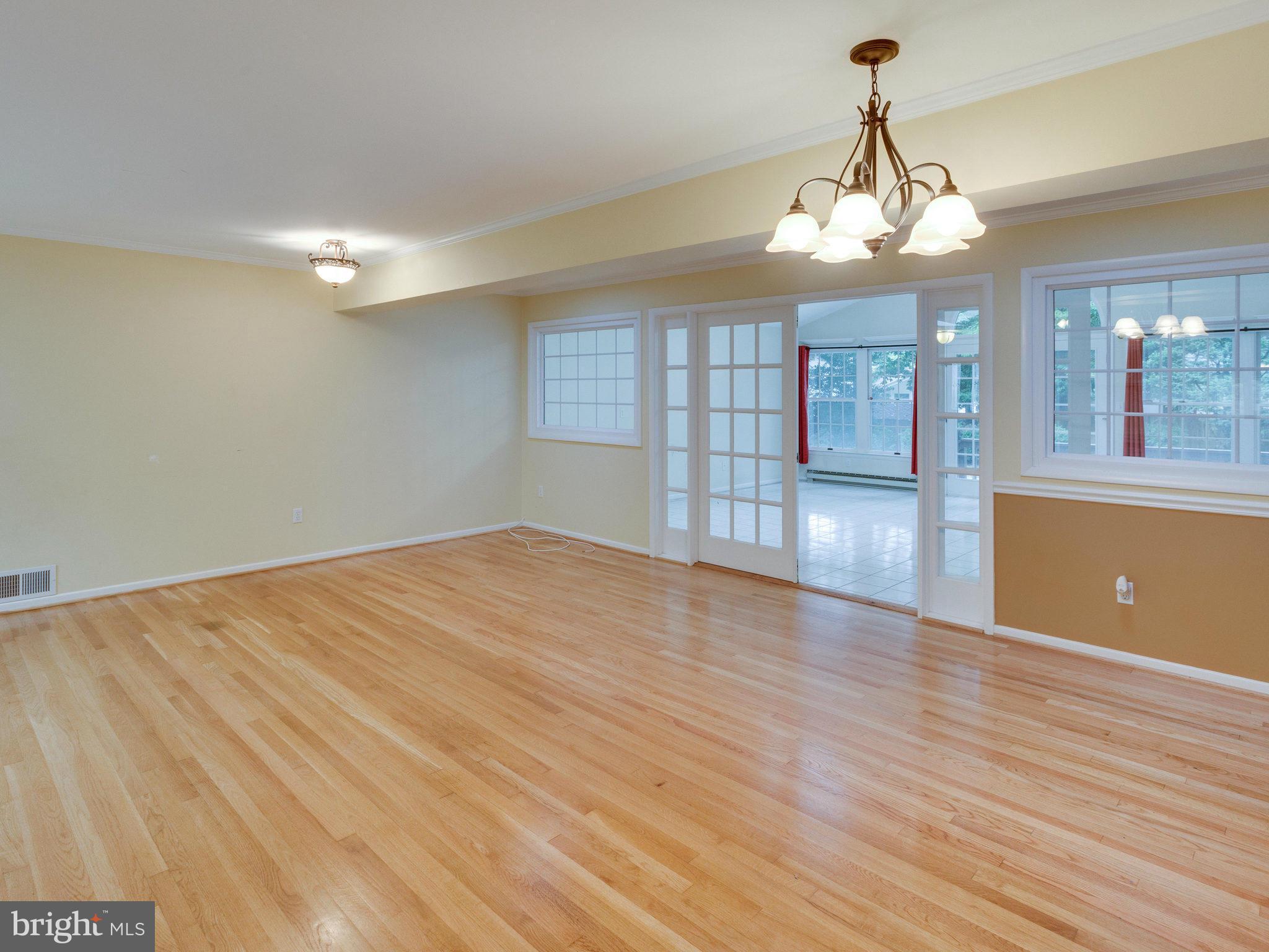10022 Ranger Road Fairfax, VA 22030 - Photo 6 of 30 a view of empty room with wooden floor and chandelier
