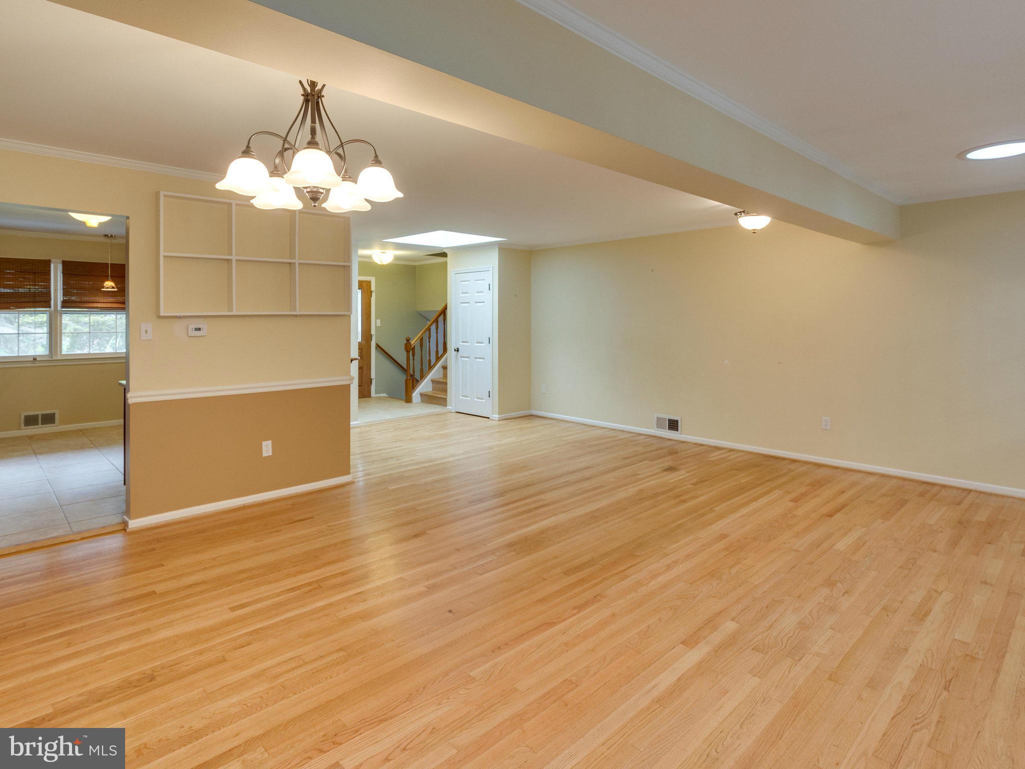 10022 Ranger Road Fairfax, VA 22030 - Photo 7 of 30 an empty room with wooden floor and chandelier fan