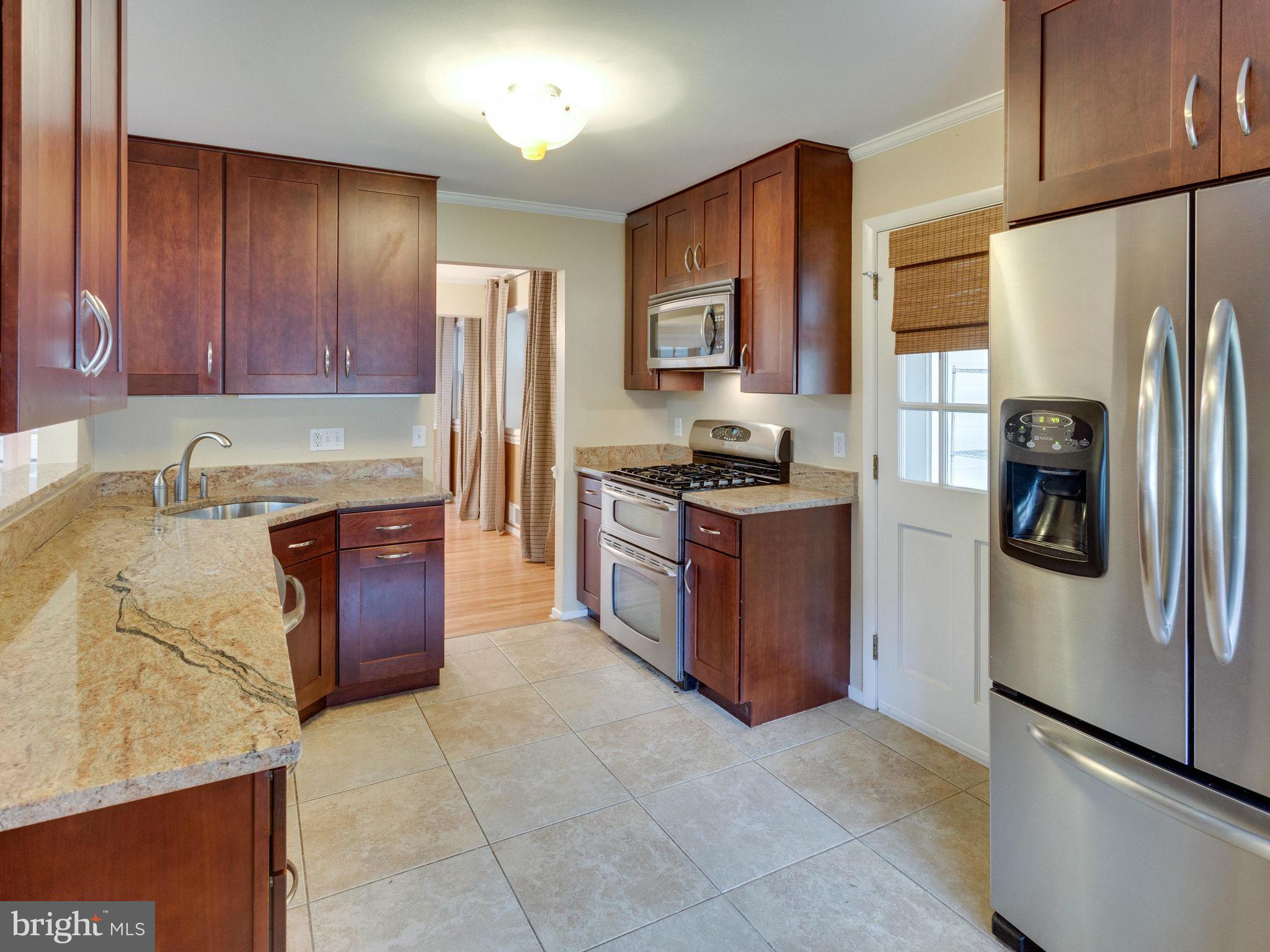 10022 Ranger Road Fairfax, VA 22030 - Photo 8 of 30 a kitchen with stainless steel appliances granite countertop a refrigerator stove and a sink