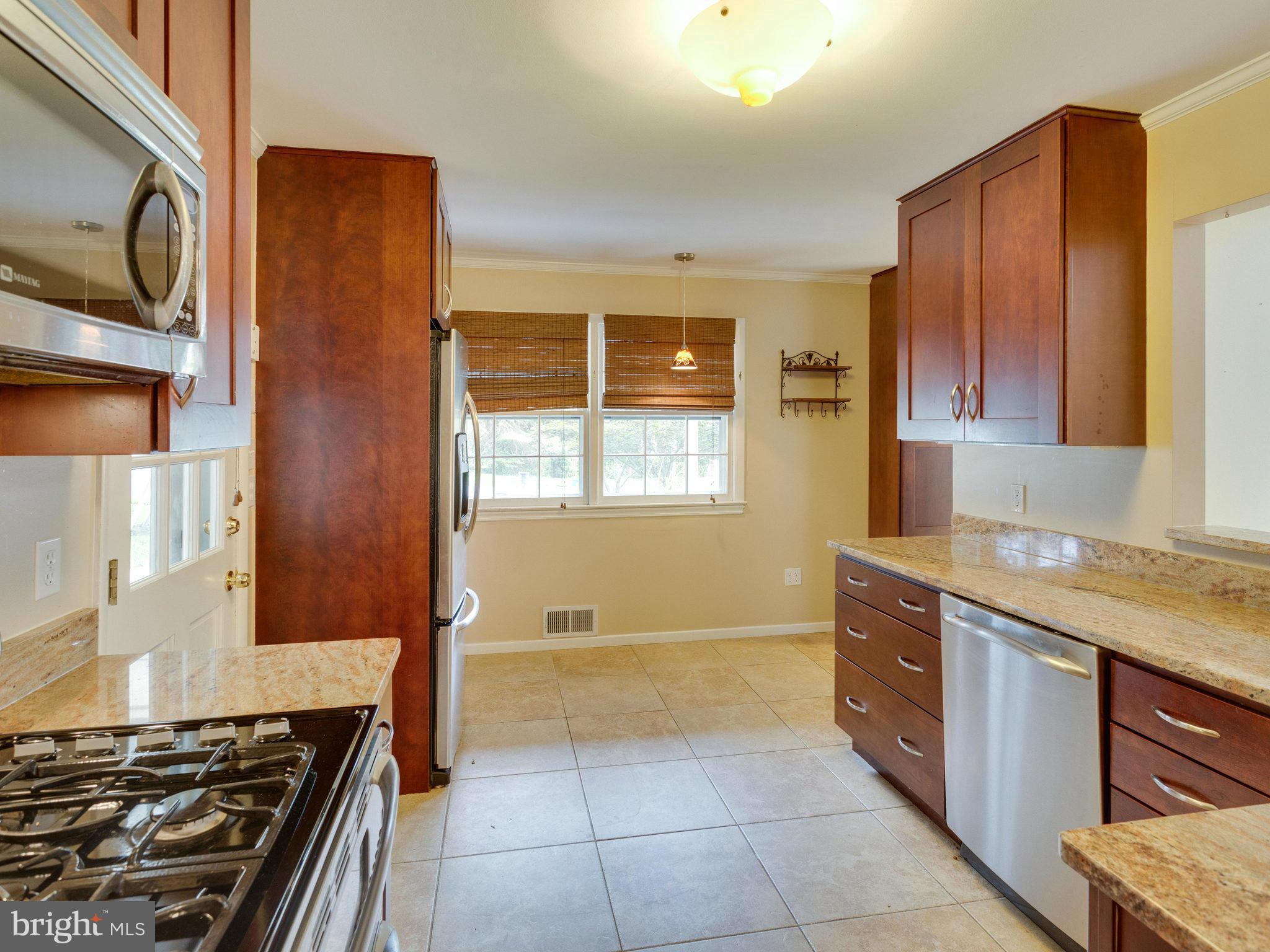 10022 Ranger Road Fairfax, VA 22030 - Photo 10 of 30 a kitchen with granite countertop a stove and a sink