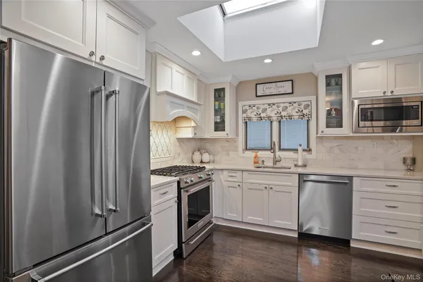 a kitchen with stainless steel appliances granite countertop a stove and a refrigerator