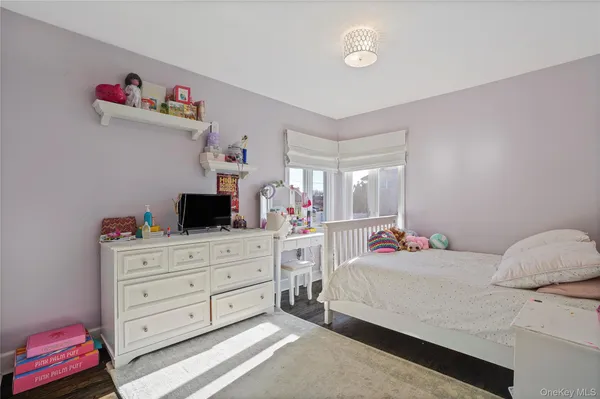 a bedroom with a bed and a television