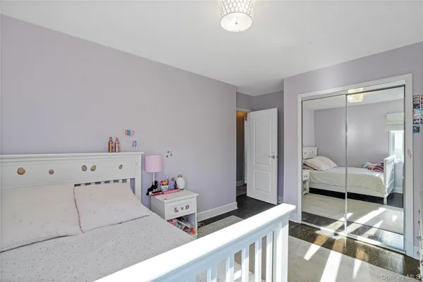 a bedroom with a bed and large mirror