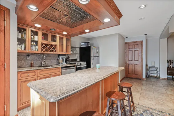 a kitchen with stainless steel appliances granite countertop a sink and cabinets