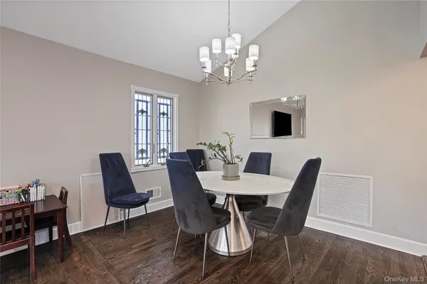 a view of a dining room with furniture and chandelier
