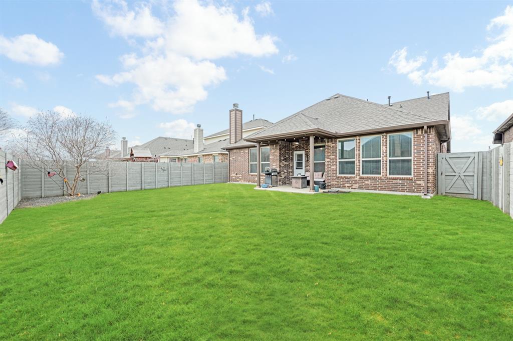 916 Falcon Road Argyle, TX 76226 - Photo 3 of 37 Rear view of house featuring a yard and a patio