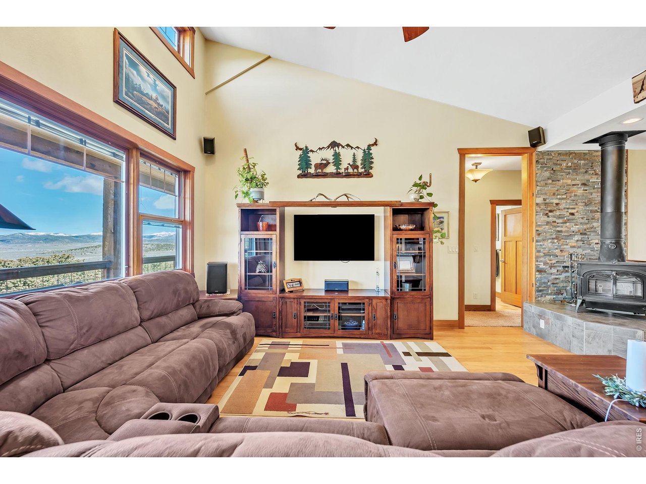 3237 Romnes Road Fort Garland, CO 81133 - Photo 12 of 42 a living room with furniture flat screen tv and a large window