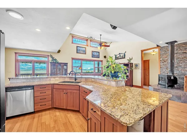 a kitchen with granite countertop sink and cabinets