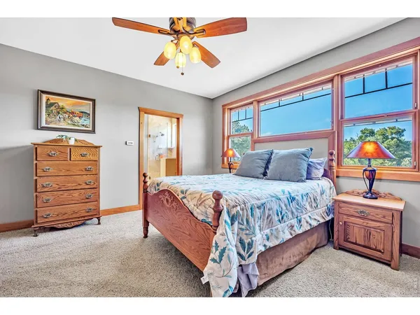 a bedroom with a bed and dresser with mirror