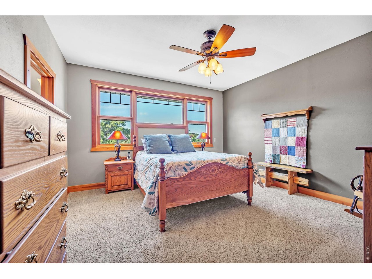 3237 Romnes Road Fort Garland, CO 81133 - Photo 19 of 42 a bedroom with a bed and a chandelier