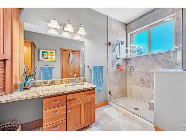 a bathroom with a granite countertop sink mirror and double