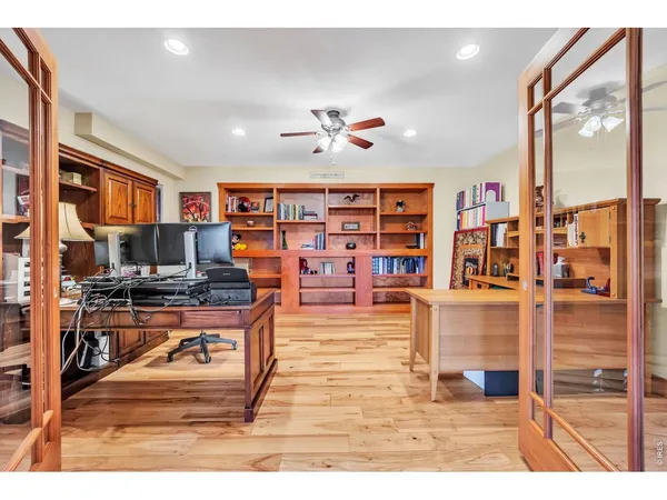 a living room with furniture a flat screen tv and a floor to ceiling window