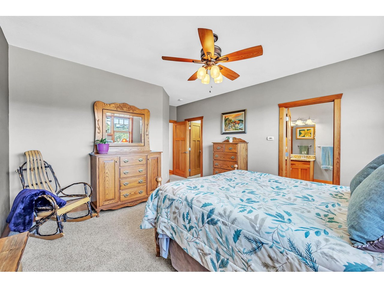 3237 Romnes Road Fort Garland, CO 81133 - Photo 30 of 42 a bedroom with a bed and a chandelier