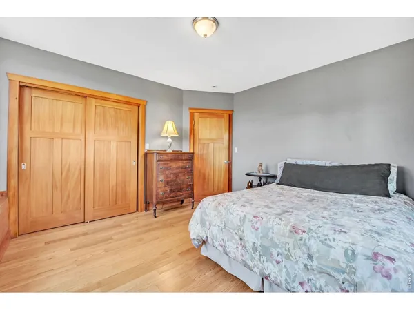 a bedroom with a large bed and a chandelier