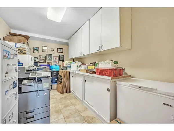 a storage room with cabinets washer and dryer