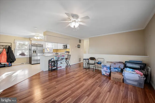 a kitchen with stainless steel appliances a stove a microwave a sink and cabinets