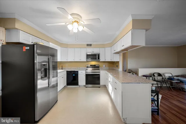 a kitchen with a stove a refrigerator and a microwave