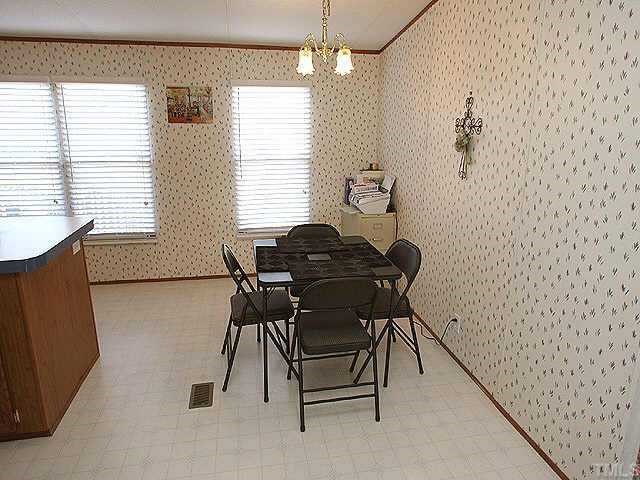 199 Maple Road Angier, NC 27501 - Photo 4 of 8 a dining room with furniture and window