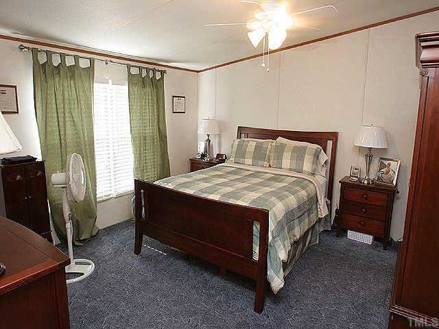 199 Maple Road Angier, NC 27501 - Photo 5 of 8 a bed sitting in a room next to a window