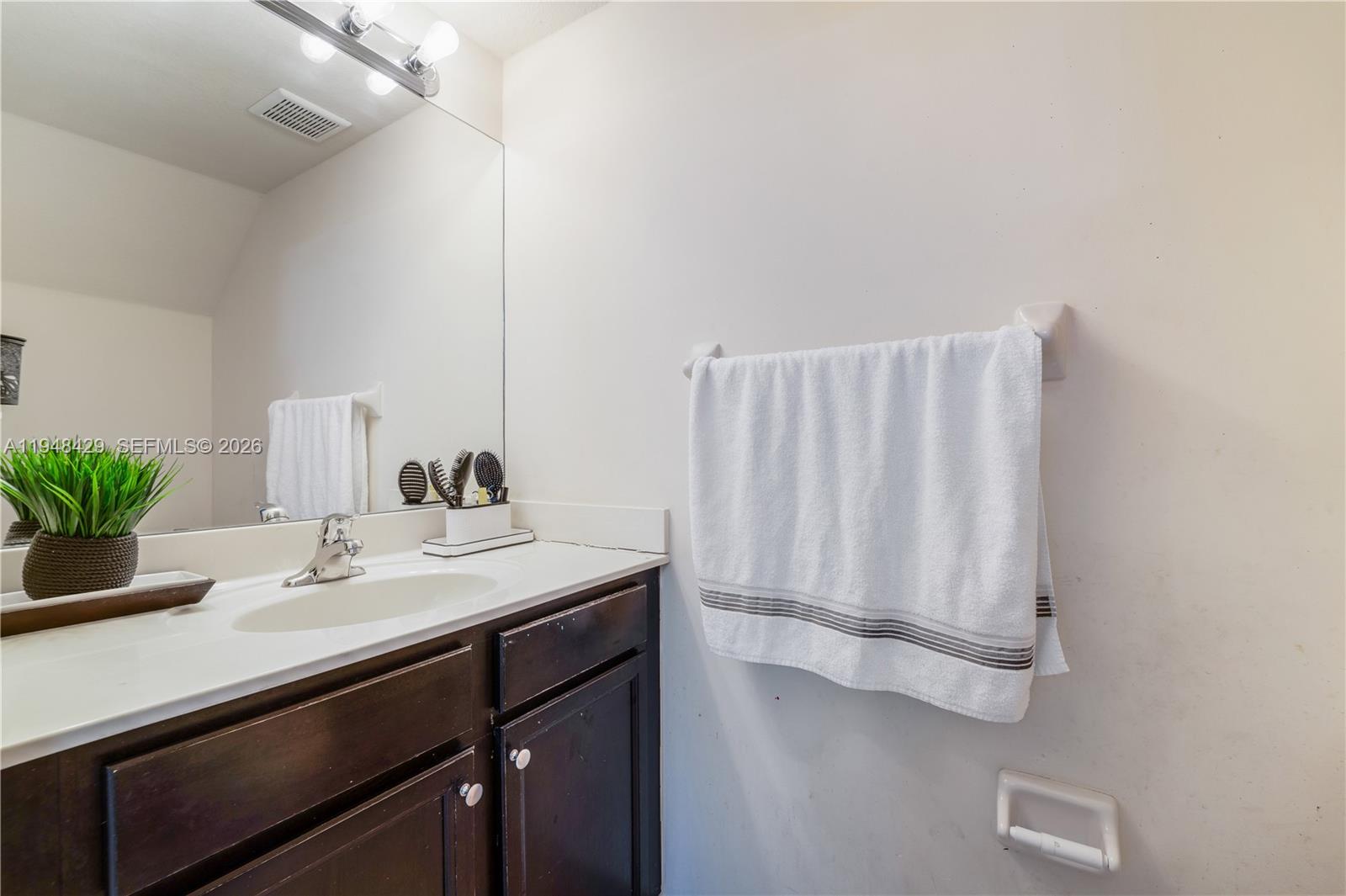 9360 Southwest 171st Court Miami, FL 33196 - Photo 11 of 43 a bathroom with a sink and a mirror