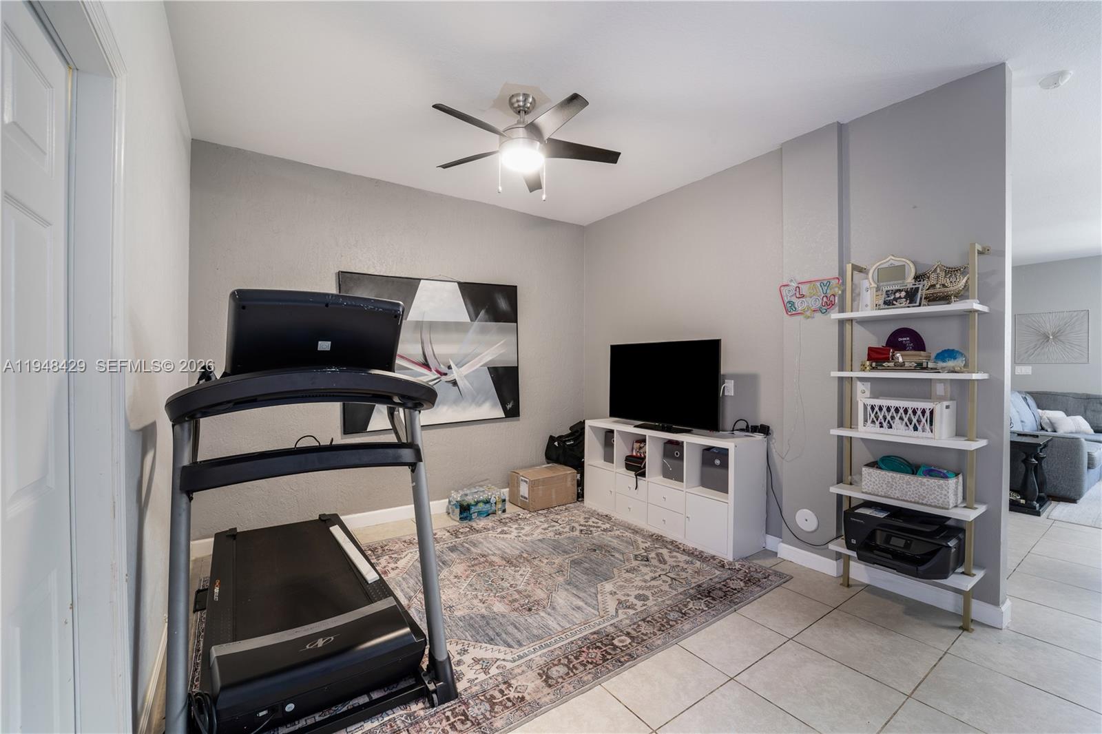 9360 Southwest 171st Court Miami, FL 33196 - Photo 13 of 43 a living room with furniture and a flat screen tv