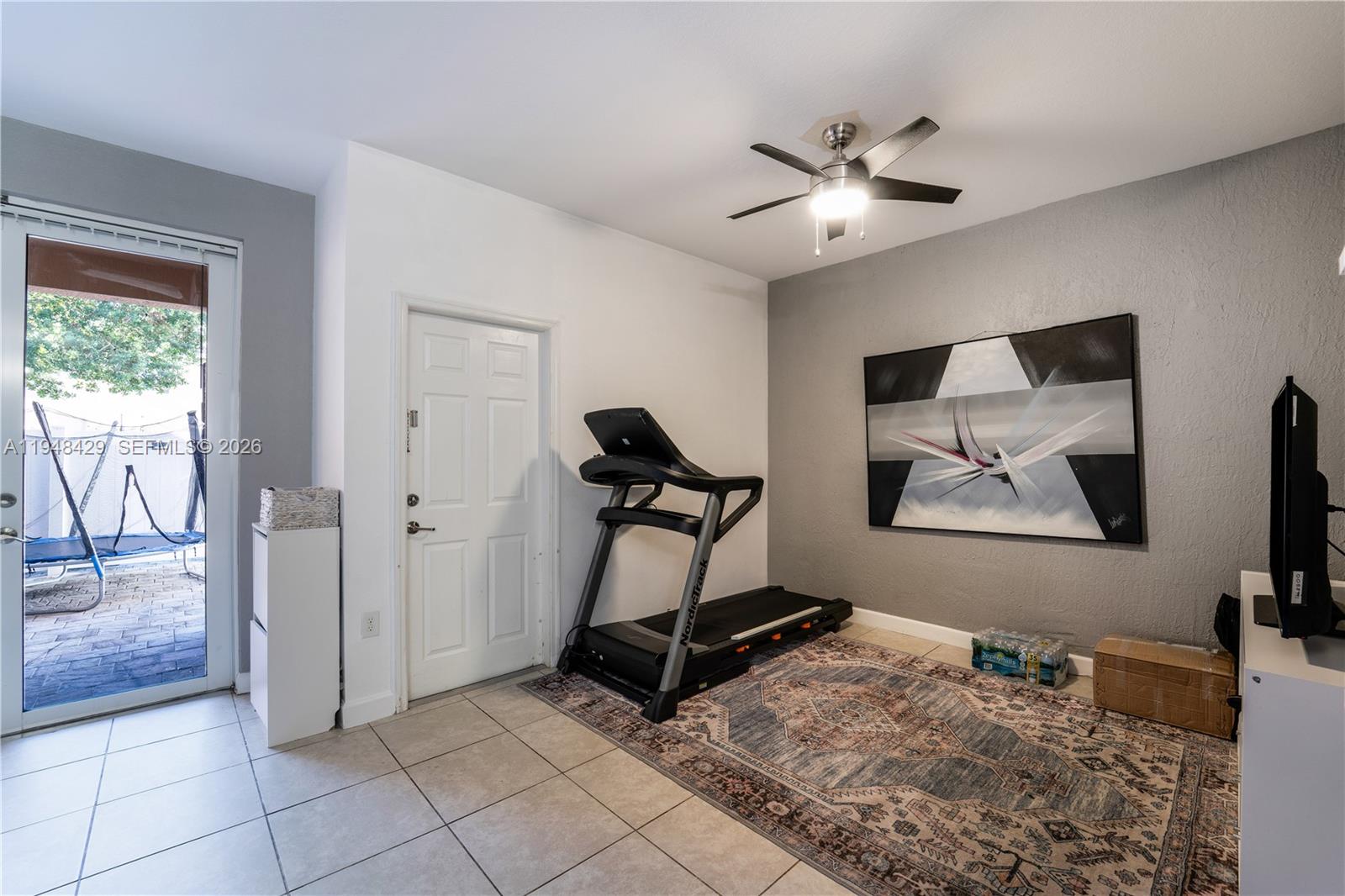 9360 Southwest 171st Court Miami, FL 33196 - Photo 14 of 43 a living room with furniture and a flat screen tv