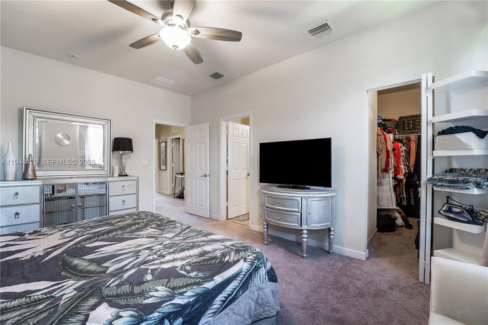 9360 Southwest 171st Court Miami, FL 33196 - Photo 22 of 43 a bedroom with a bed and a flat screen tv