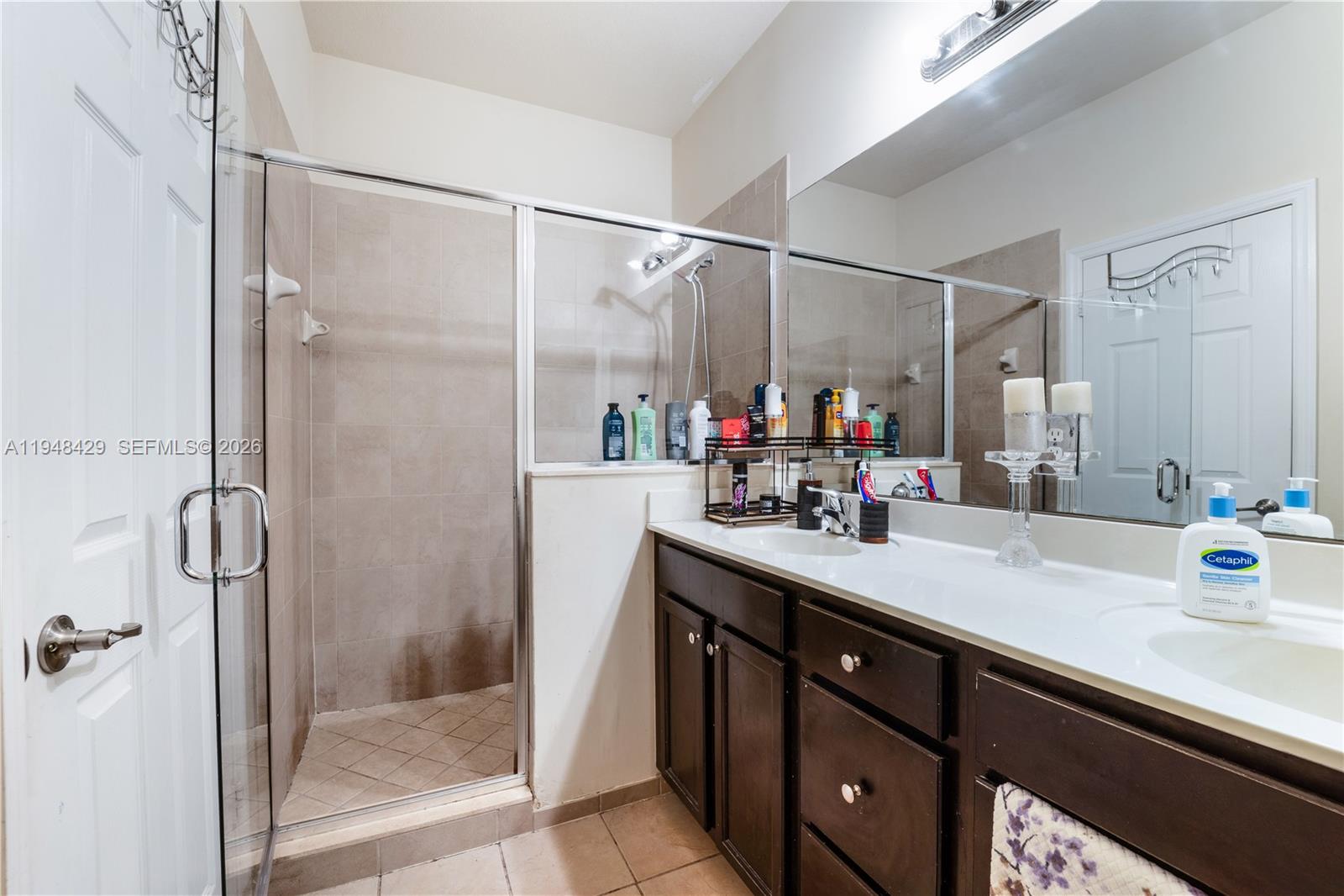 9360 Southwest 171st Court Miami, FL 33196 - Photo 23 of 43 a bathroom with a double vanity sink mirror and shower