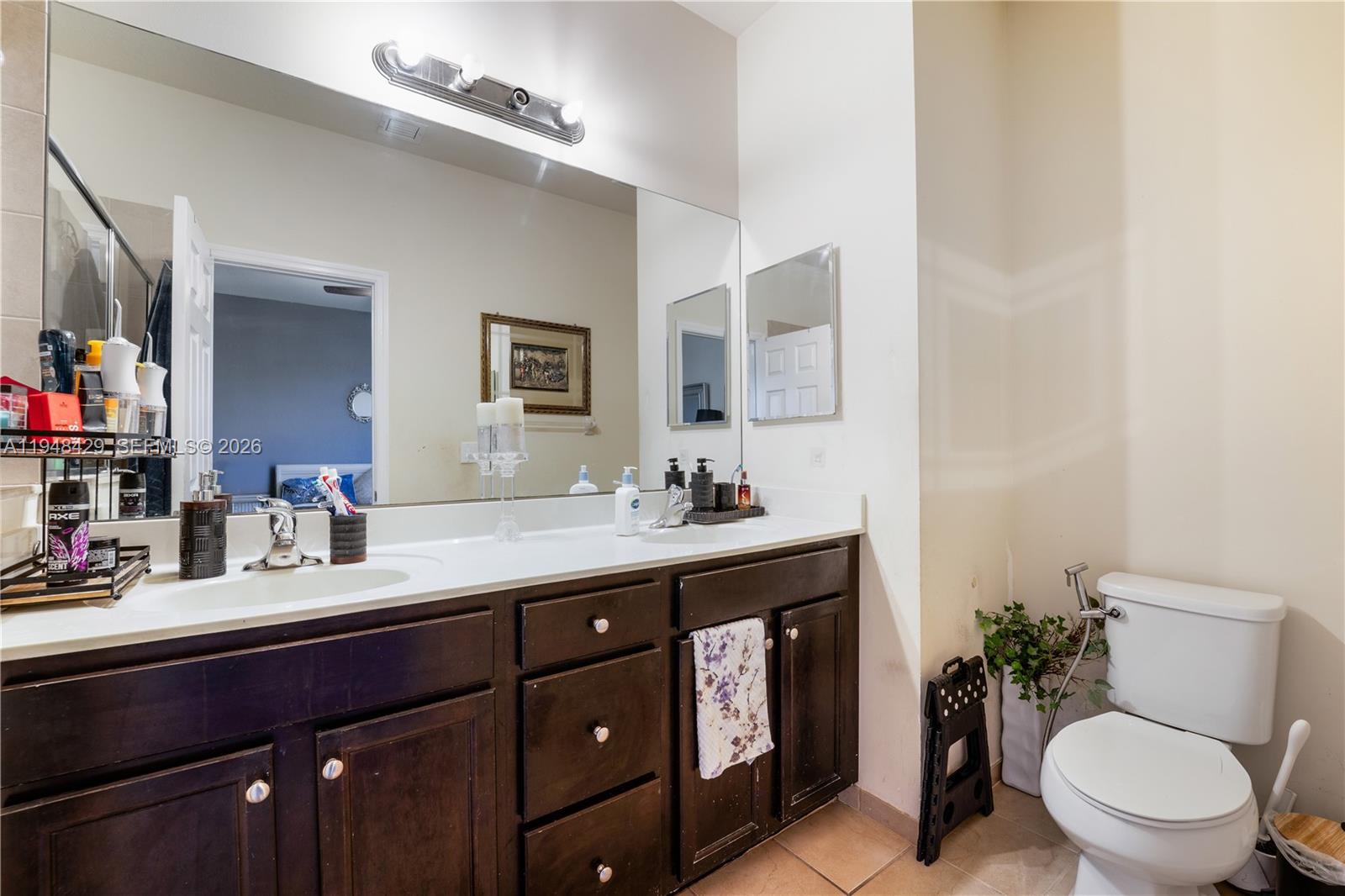 9360 Southwest 171st Court Miami, FL 33196 - Photo 24 of 43 a bathroom with a toilet a sink and mirror