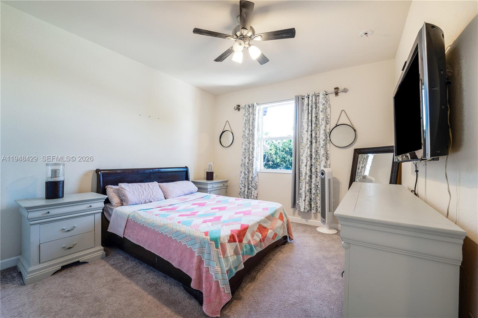 9360 Southwest 171st Court Miami, FL 33196 - Photo 27 of 43 a bedroom with a bed a window and dresser
