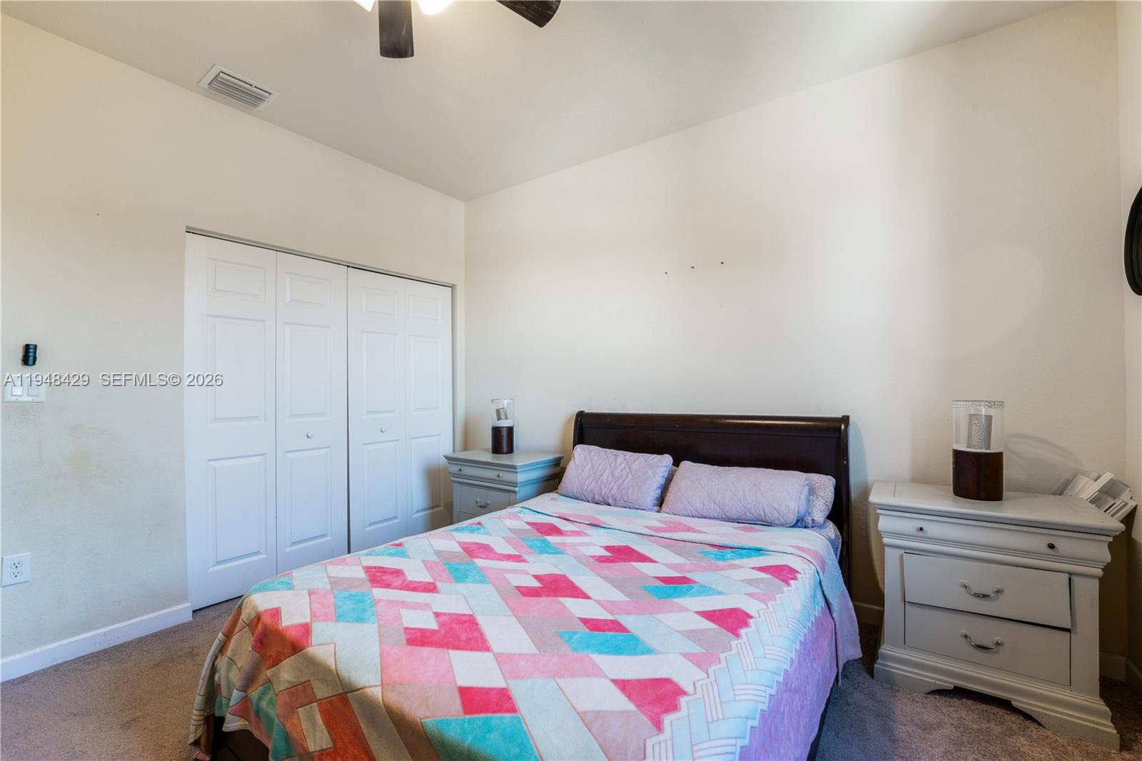 9360 Southwest 171st Court Miami, FL 33196 - Photo 28 of 43 a bedroom with a bed and a chandelier