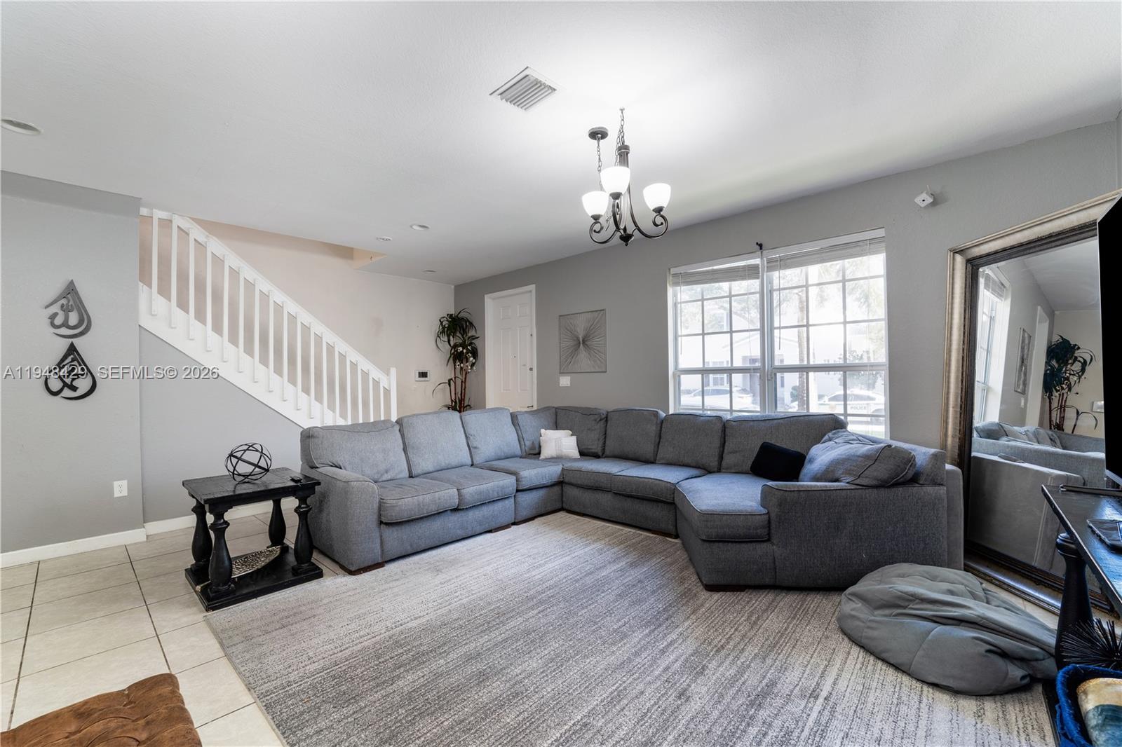 9360 Southwest 171st Court Miami, FL 33196 - Photo 7 of 43 a living room with furniture and a wooden floor