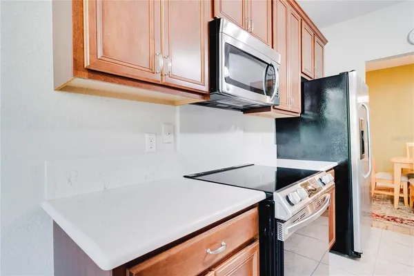 a kitchen with stainless steel appliances granite countertop a stove a microwave and a refrigerator