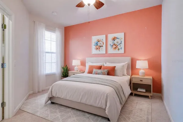 a bedroom with a bed and a chandelier