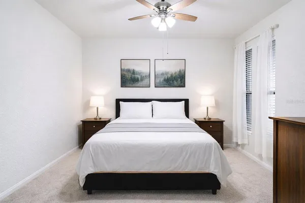 a bedroom with a bed and a chandelier