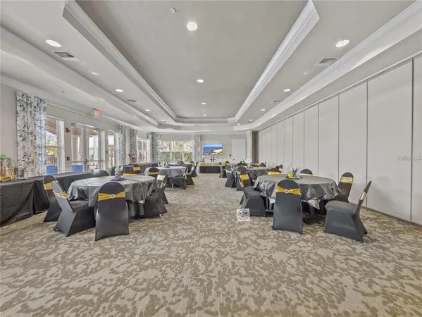 a living room with lots of furniture and view of kitchen