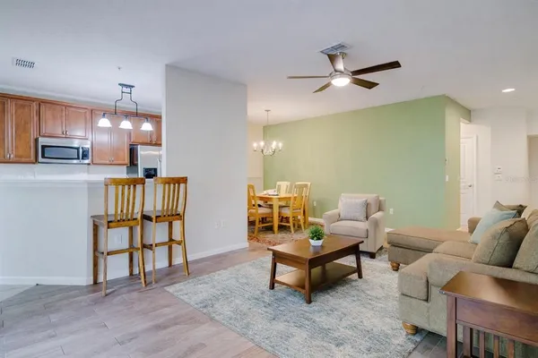 a living room with furniture and kitchen view