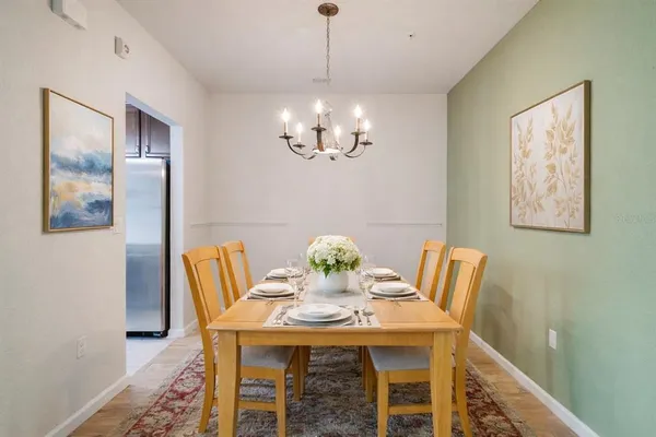 a view of a dining room with furniture and chandelier