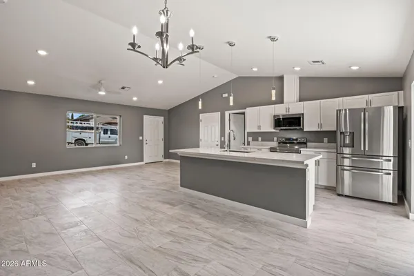 a large kitchen with cabinets and stainless steel appliances