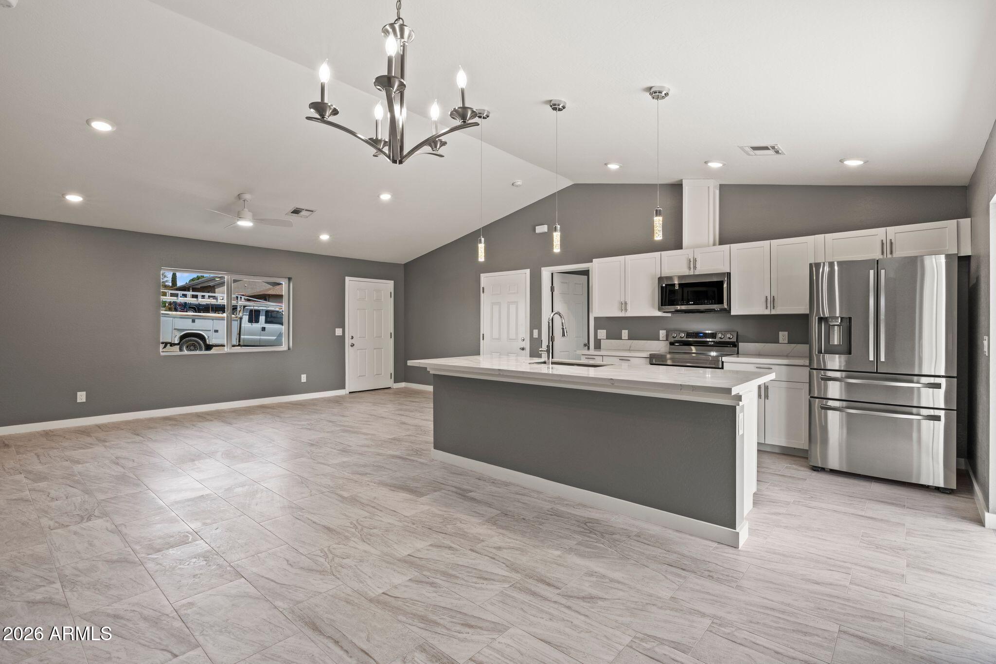 17933 East Bob White Road Mayer, AZ 86333 - Photo 17 of 30 a large kitchen with cabinets and stainless steel appliances