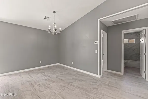 a view of a chandelier in big room and hallway